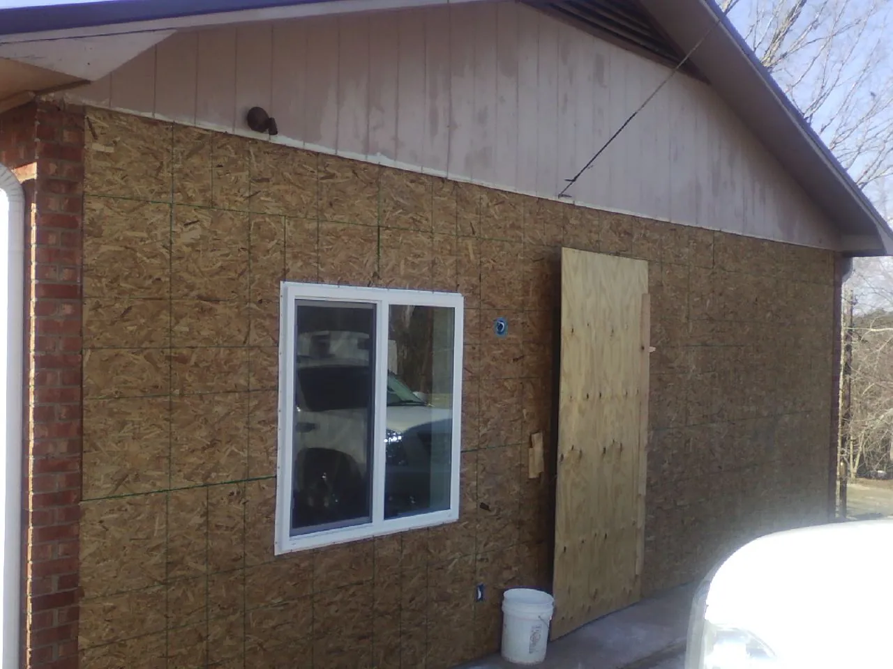 OSB sheathing on a garage addition wall before siding in La Fayette