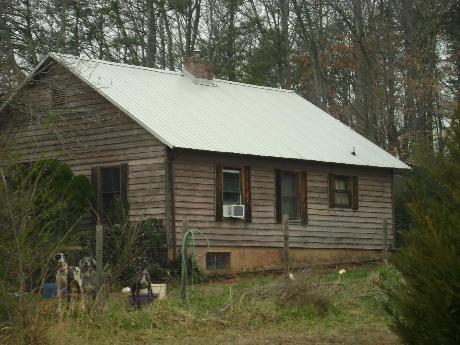 White metal roof on an old wood sided farmhouse, from a Metal Roof Installation job in La Fayette